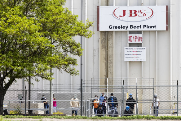 Employees exit from the JBS Beef Production Facility in Greeley, Colorado.