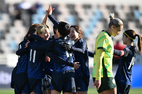 Mina Tanaka celebrates with teammates after scoring for Japan.