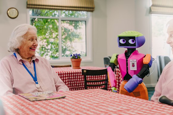 Andromeda’s Abi with residents in a Mecwacare facility.