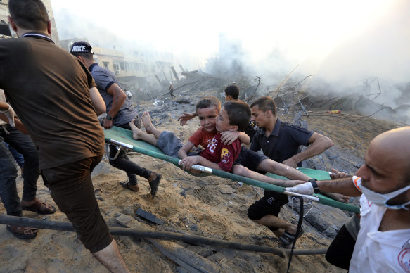Two boys are rescued from the rubble after Israeli airstrikes on Gaza City