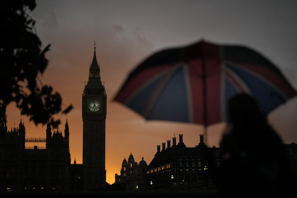 A woman walked past the sunset on Big Ben People as she queued to pay their respects to late Queen Elizabeth II in September.