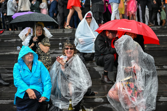 Race fans in a downpour at the Melbourne Cup at Flemington Racecourse on Tuesday. 