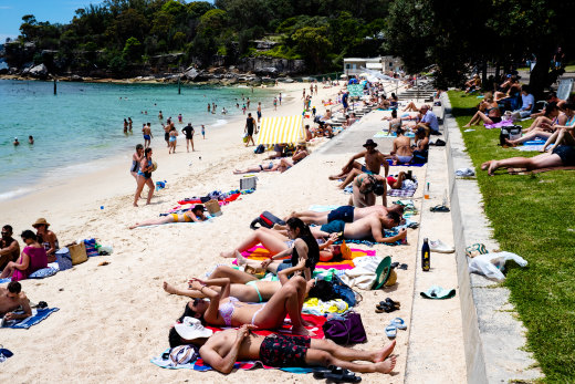 Beachgoers sprawled on the sand to soak up the sunshine at Nielsen Park in Vaucluse. 