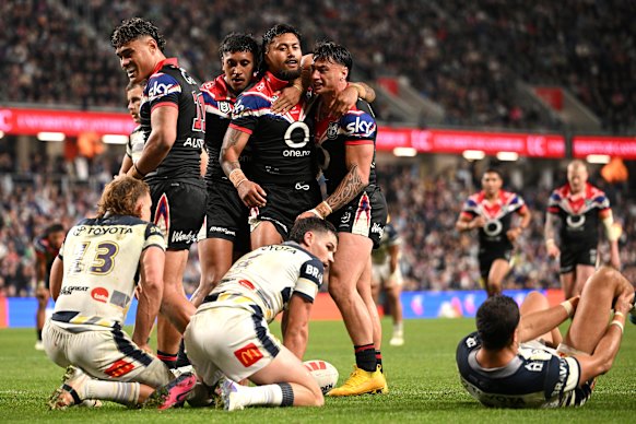 The Warriors celebrate an Adam Pompey try against the Cowboys.