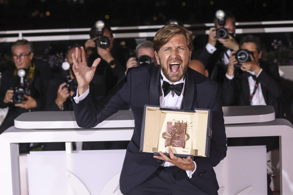 Triangle of Sadness director Ruben Ostlund poses with the Palme d’Or at the Cannes Film Festival.
