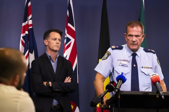 Deputy Commissioner David Hudson speaks while Premier Chris Minns watches on.