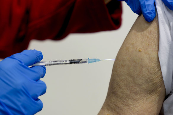 An 87-year-old man gets his booster shot at the vaccination centre in Frankfurt, Germany.