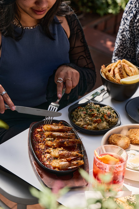 Snacks include prawn saganaki and eggplant dip.