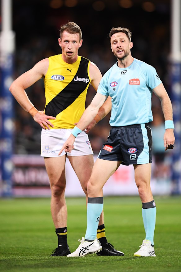 Umpire Brett Rosebury points to the mark for Richmond’s Dylan Grimes.