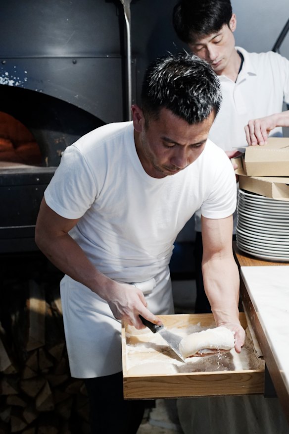 Shaping dough at Pizza Studio Tamaki.