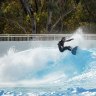 Veteran pro surfer Tom Carroll rides a wave at the new Homebush Bay facility.