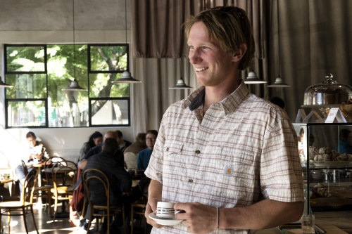 A customer enjoying the $2 espresso that’s available at Genovese Coffee House’s espresso bar.