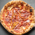 Pizza Diavola with spicy salami, onion and roasted capsicum.