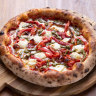 The Faz pizza topped with roasted peppers, pancetta, pesto, mozzarella and feta.