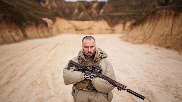 Andrii Rubliuk, a senior sergeant with a Ukrainian intelligence unit who lost both arms and a leg in combat, holds a rifle during military training near Kyiv.