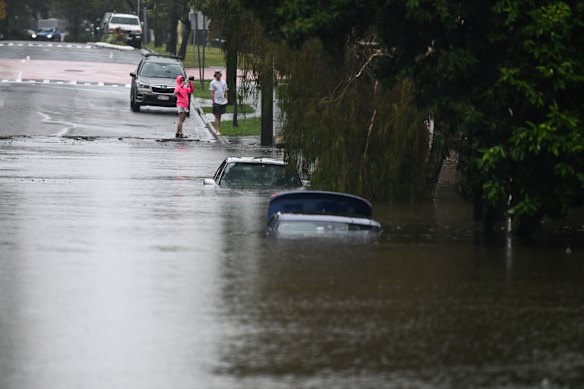 Cars are submerged in a flooded street in Newmarket.