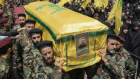 Hezbollah fighters carry the coffin of a senior commander who was killed by an Israeli strike in south Lebanon.
