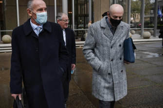 Chris Dawson, left, and his brother Peter leave the Supreme Court, where Chris is on trial for the murder of his first wife.
