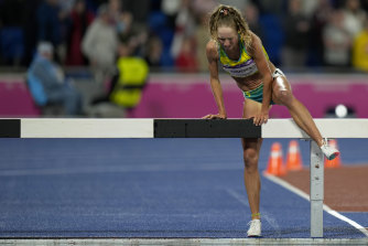 Brielle Erbacher of Australia climbs over a hurdle.