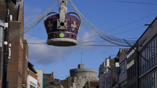 Street lights in the design of a crown hang near Windsor Castle, as the Queen rested after a night in hospital in October.