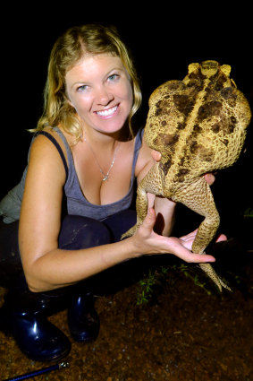 Dr Jayna DeVore pictured with a native range toad caught in the Amazon.