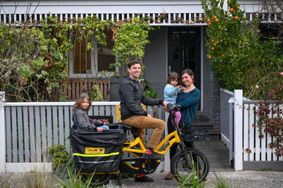 Ingrid Jolley and Chris Besley with their children, Mia (left) and Hazel, and their electric bike.