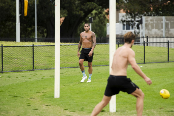 Lance Franklin training outside the SCG with a Sydney teammate on Monday.