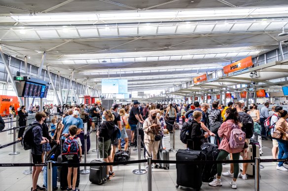 Travellers queue at Sydney’s domestic airport on Tuesday.