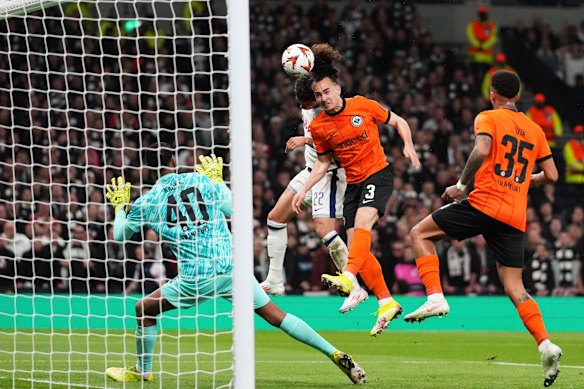 Frankfurt’s Arthur Theate, centre, clears the ball before Tottenham’s Brennan Johnson, background, can reach it.