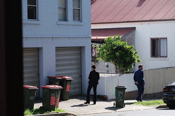 Detectives In Balmain on Friday morning. Viki Graham’s relative remains in a critical condition in hospital after her alleged attack caused a seizure and stopped his breathing.