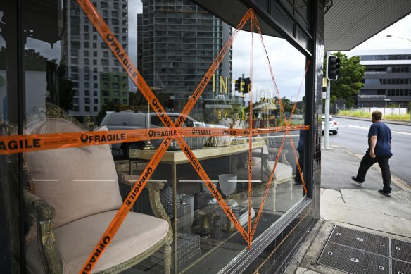 A business with taped windows in central Brisbane.