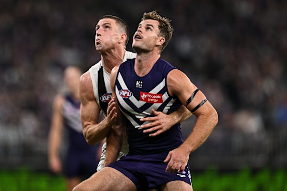 Darcy competes in a ruck contest with Darcy Cameron of the Magpies.