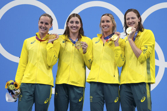 Australia’s women’s 4x100m women’s relay team in Tokyo, Bronte Campbell, Meg Harris, Emma McKeon and Cate Campbell, celebrate on the podium.