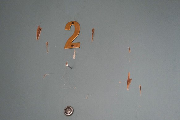 The door to a neighbour’s unit which locals say Viki Graham damaged in 2022.