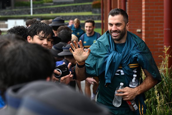 James Tedesco greets students at the Anglican Church Grammar School in Brisbane after Kangaroos training.