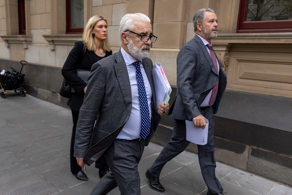 Richard Edney (centre) outside court.