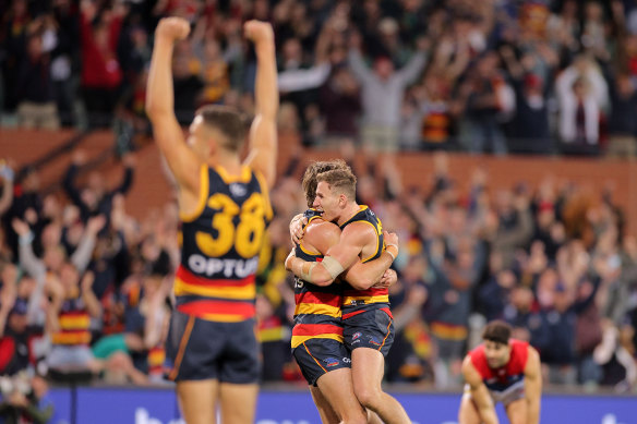 Crows players celebrate after the final siren.