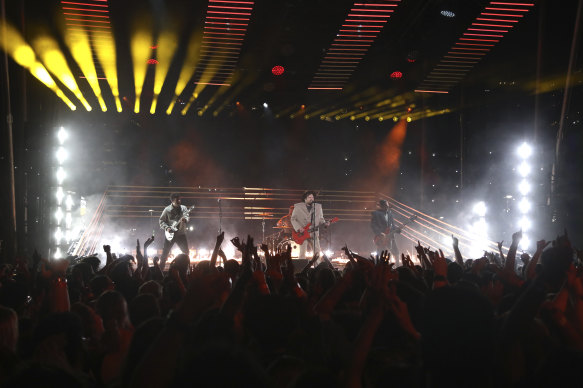 Joe Trohman, from left, Andy Hurley, Patrick Stump, and Pete Wentz of Fall Out Boy perform.