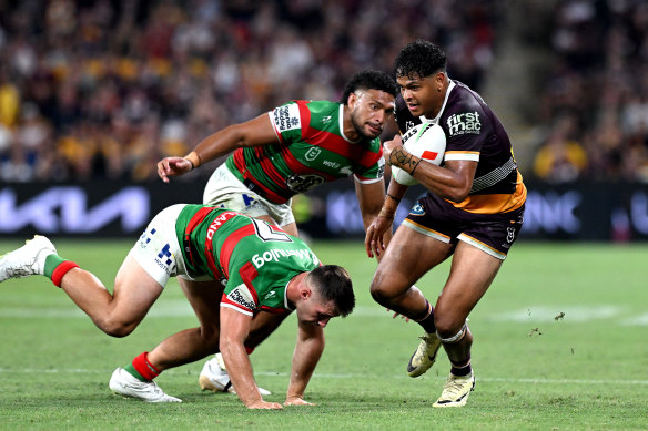 Selwyn Cobbo of the Broncos breaks away from the Souths’ defence.