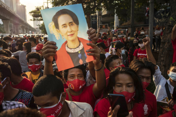 Pro-democracy protesters hold an image of Aung San Suu Kyi during a protest outside Myanmar’s embassy in Bangkok on Monday.