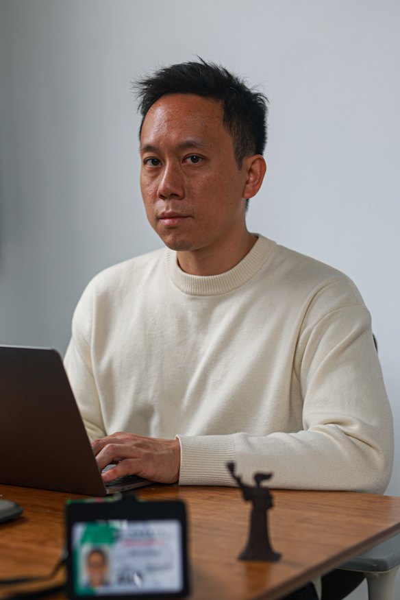 Lam Yin-Pong at his desk with a statuette of the Hong Kong ‘Goddess of Democracy’, based on the statue at the 1989 Tiananmen Square protests.