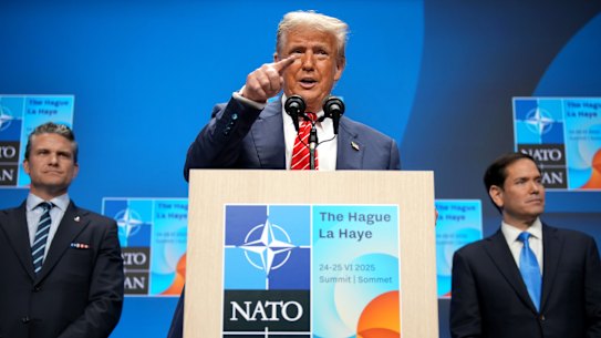 US President Donald Trump is flanked by Defence Secretary Pete Hegseth and Secretary of State Marco Rubio as speaks to the press following the NATO summit.