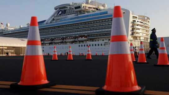A security guard stands near the quarantined Diamond Princess cruise ship.