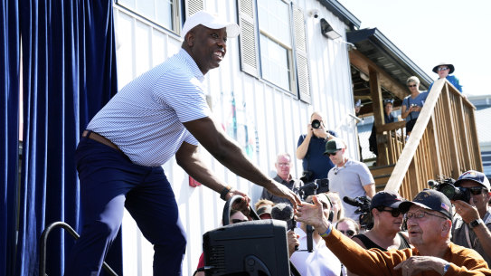 Republican presidential candidate Sen. Tim Scott greets audience members before speaking at a Fair-Side Chat at the Iowa Fair.