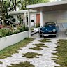Zoysia inching across a driveway in a garden designed by Paul Pritchard Landscape Design