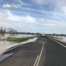 Man airlifted from Queensland floodwaters as ex-tropical cyclone looms