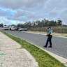 Police at the scene in Alexander Heights, where an infant’s body has been found in a stormwater drain.