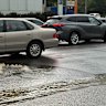Water overflows from a drain on a road in Indooroopilly.