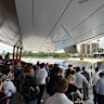 Passengers mill at a Brisbane River ferry terminal after being told to alight from a CityCat.