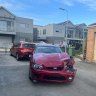 A damaged car in a laneway where a driver crashed into two children.